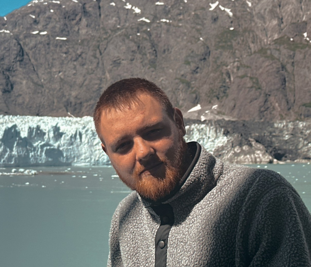 Portrait of the founder of MadeforMe in front of a glacier in Alaska